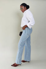 Profile view of tall model wearing MODACCIO Livia Jean in light wash denim